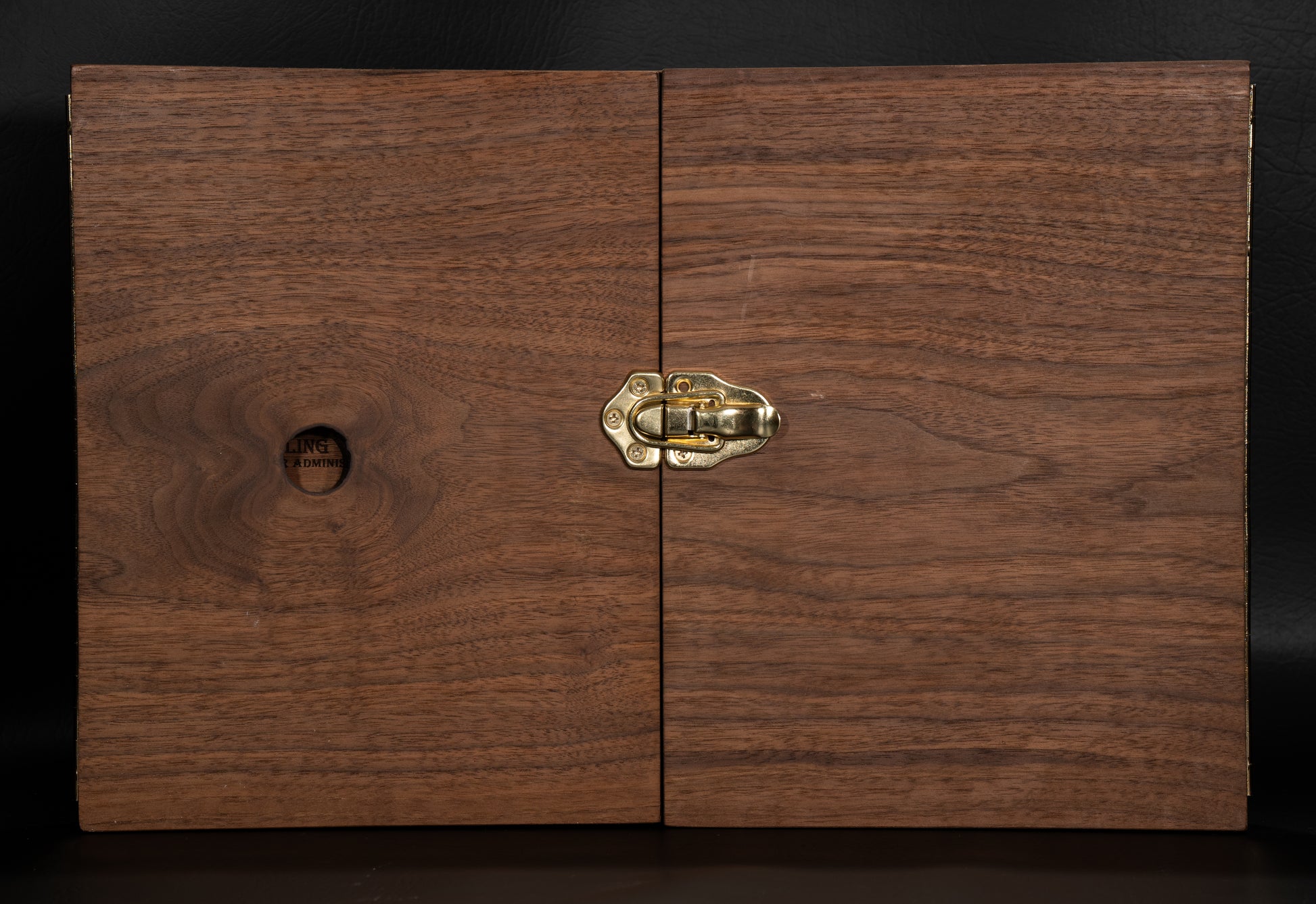 Walnut Wooden Game Master Screen Closed with a golden lock keeping the box closed.