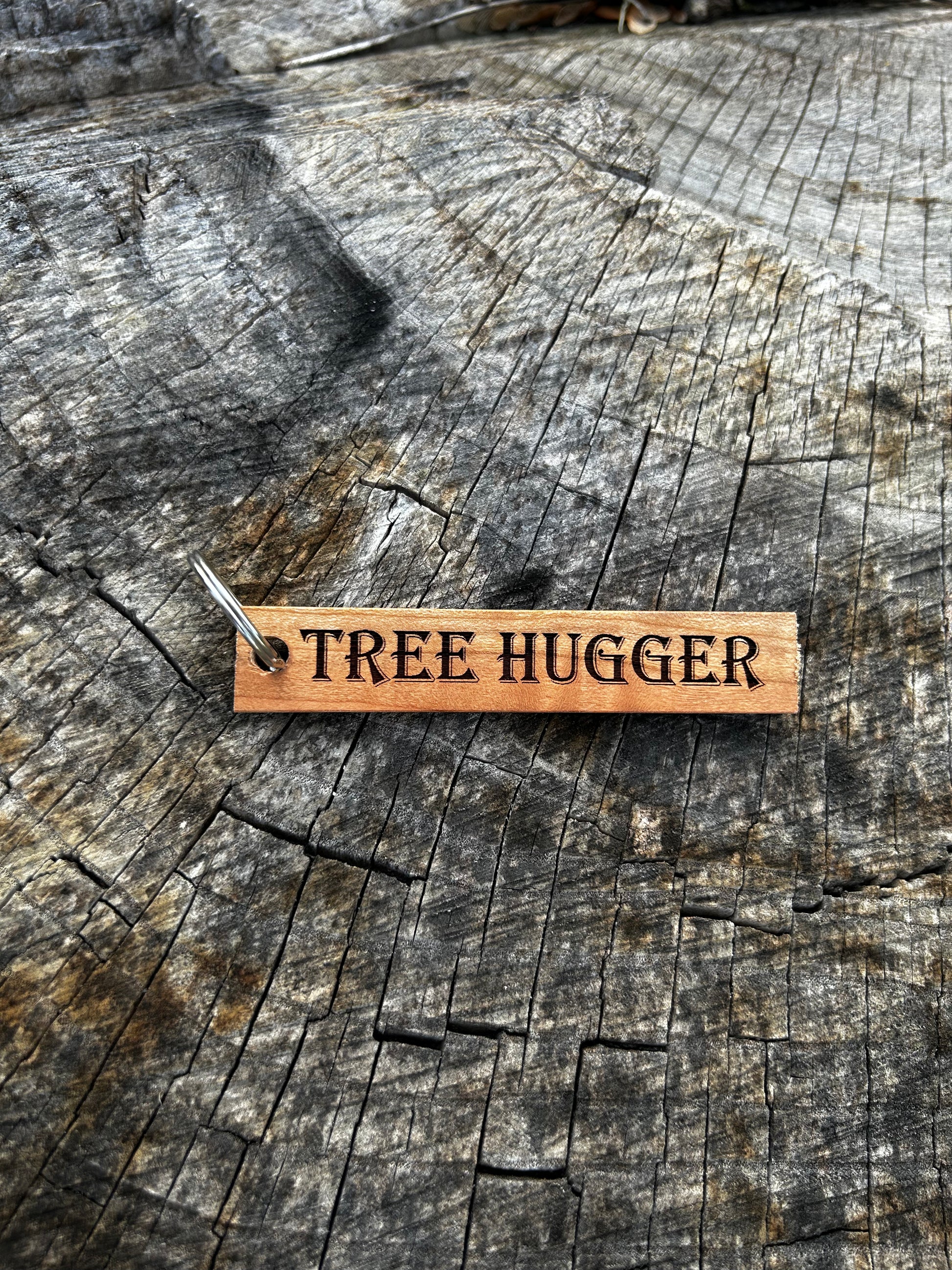 Cherry Wooden Keychain with the word "Tree Hugger" and the Oakley Nerd Nook logo pressed into it