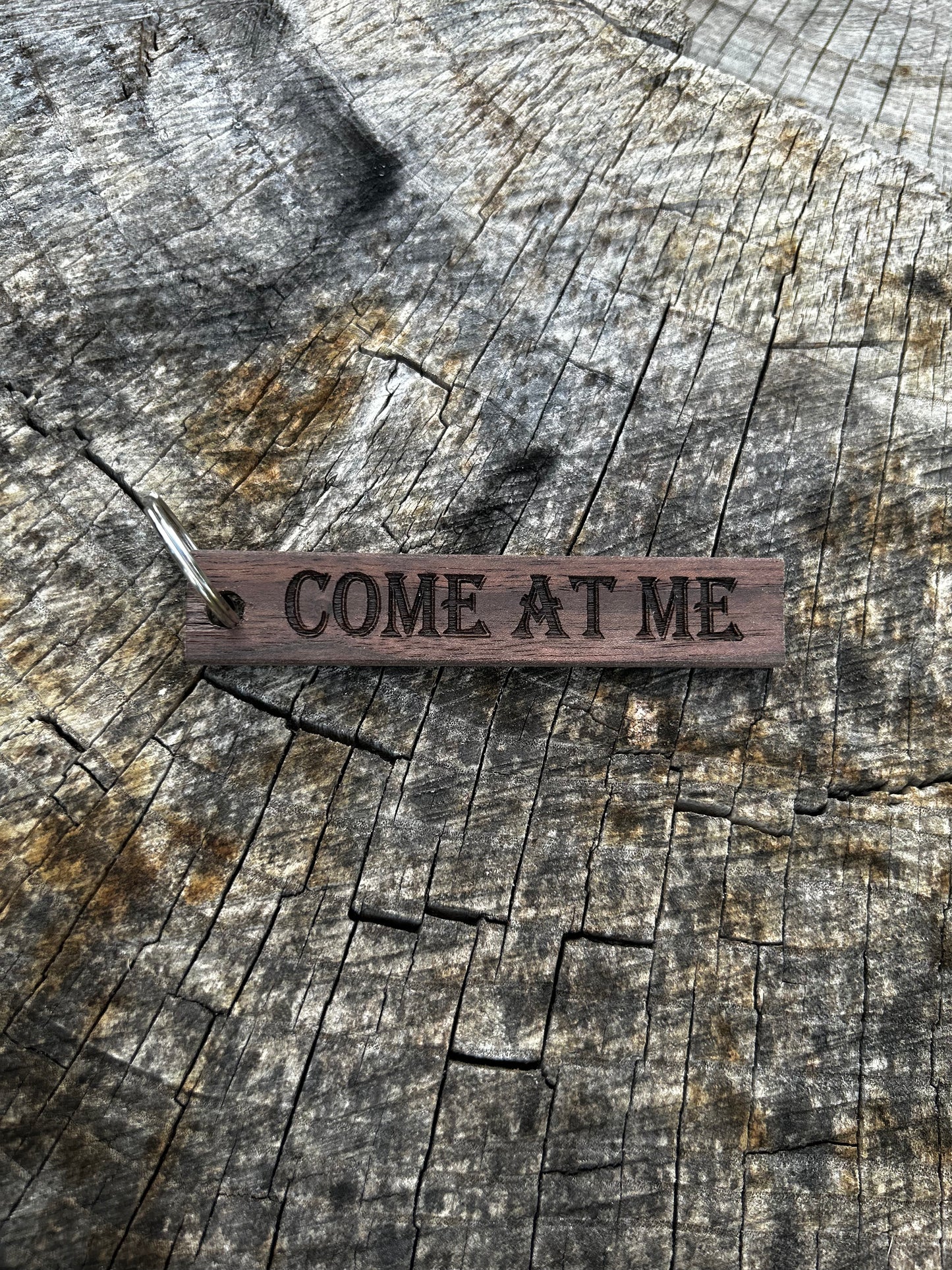 Willow Wooden Keychain with the word "Come At Me" and the Oakley Nerd Nook logo pressed into it