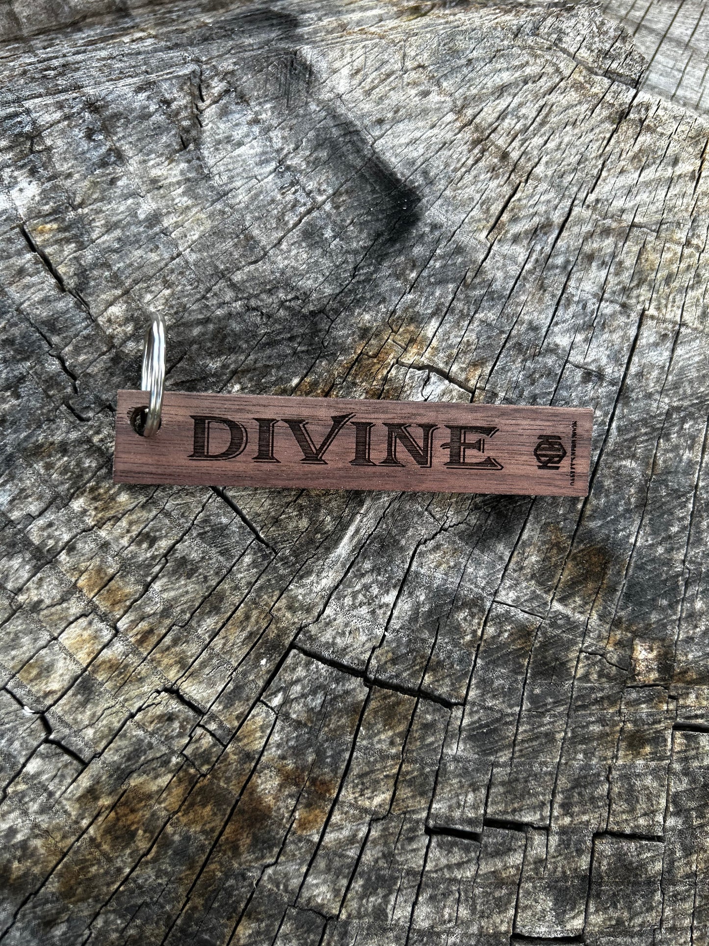 Willow Wooden Keychain with the word "Divine" and the Oakley Nerd Nook logo pressed into it