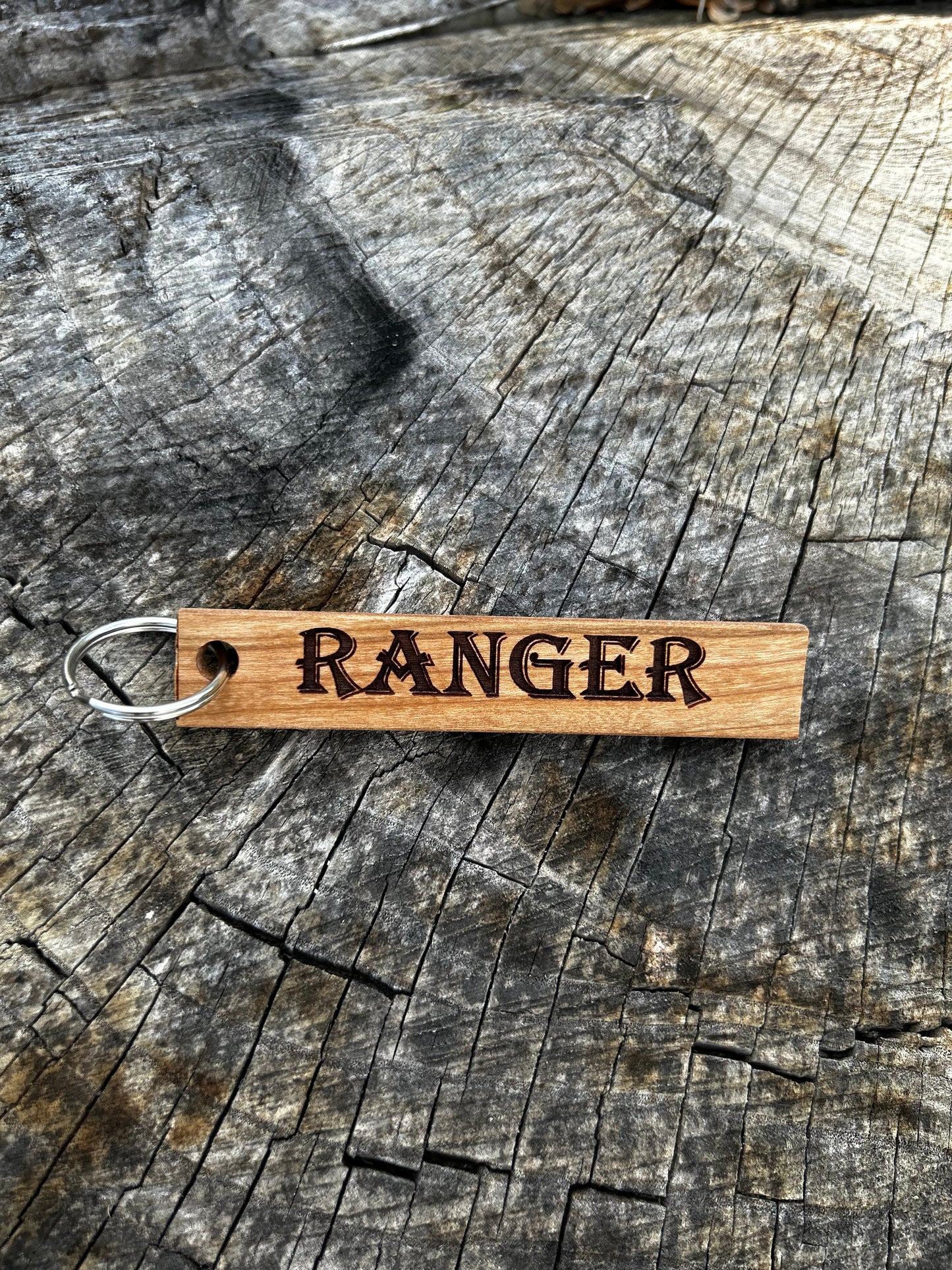 Textured Wooden Keychain with the word "Ranger" and the Oakley Nerd Nook logo pressed into it