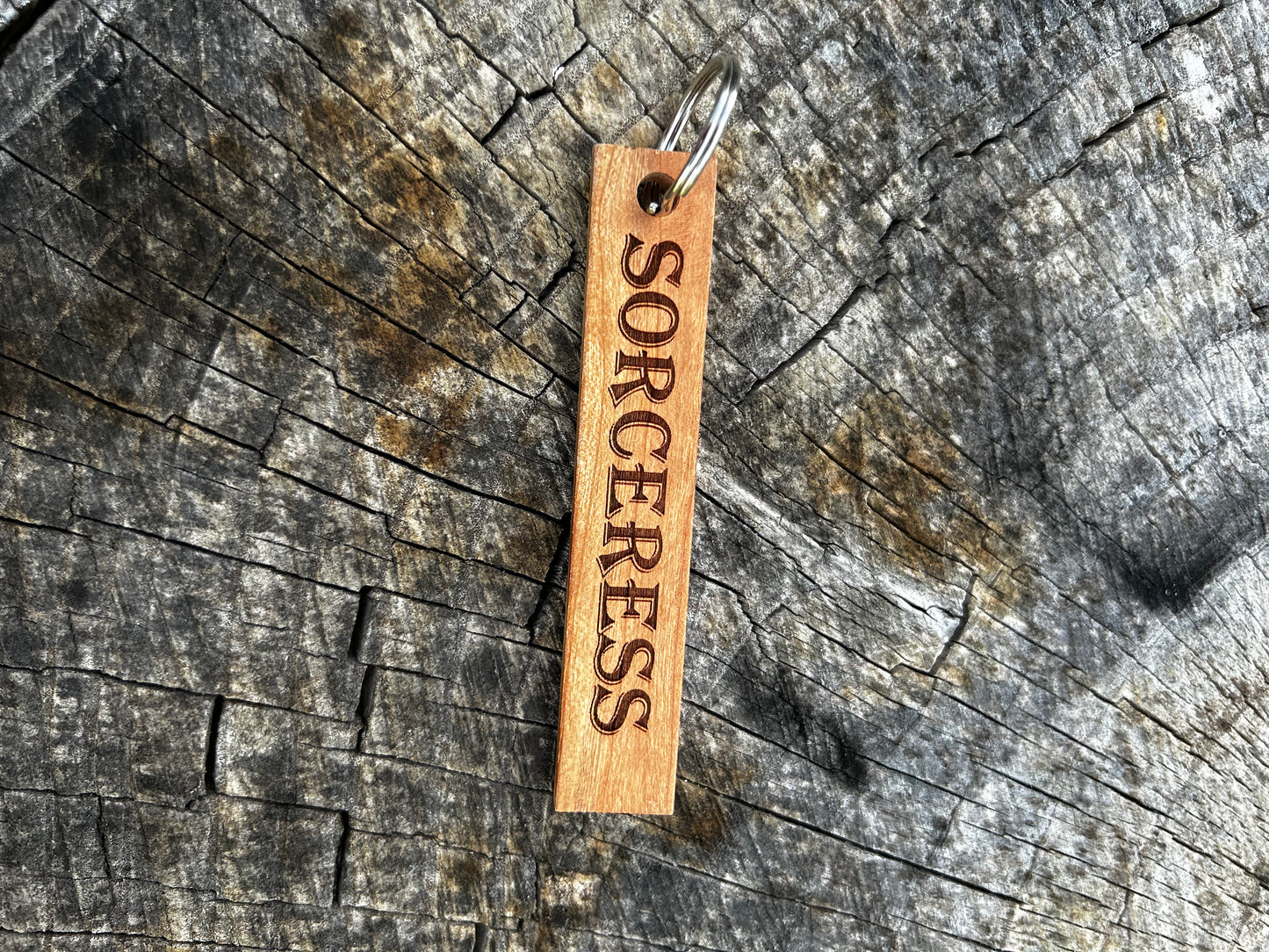 Textured Wooden Keychain with the word "Sorceress" and the Oakley Nerd Nook logo pressed into it