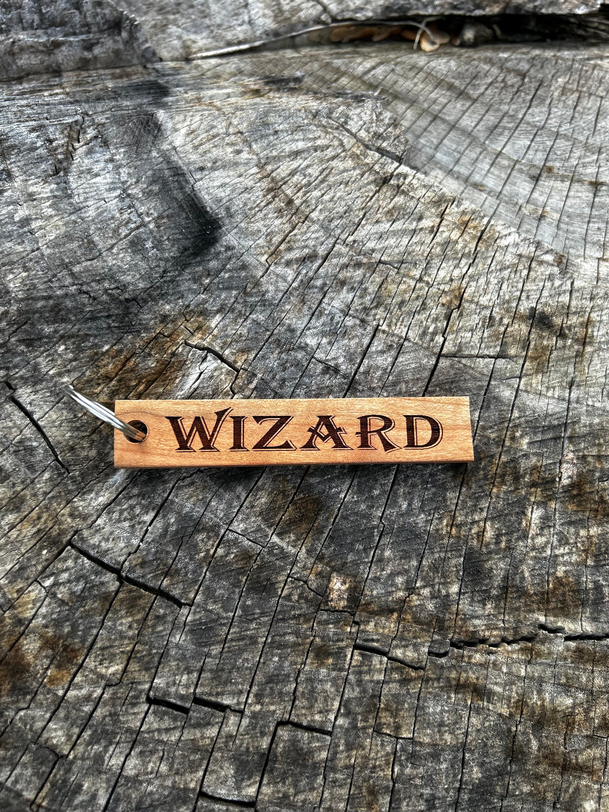 Oak Wooden Keychain with the word "Wizard" and the Oakley Nerd Nook logo pressed into it