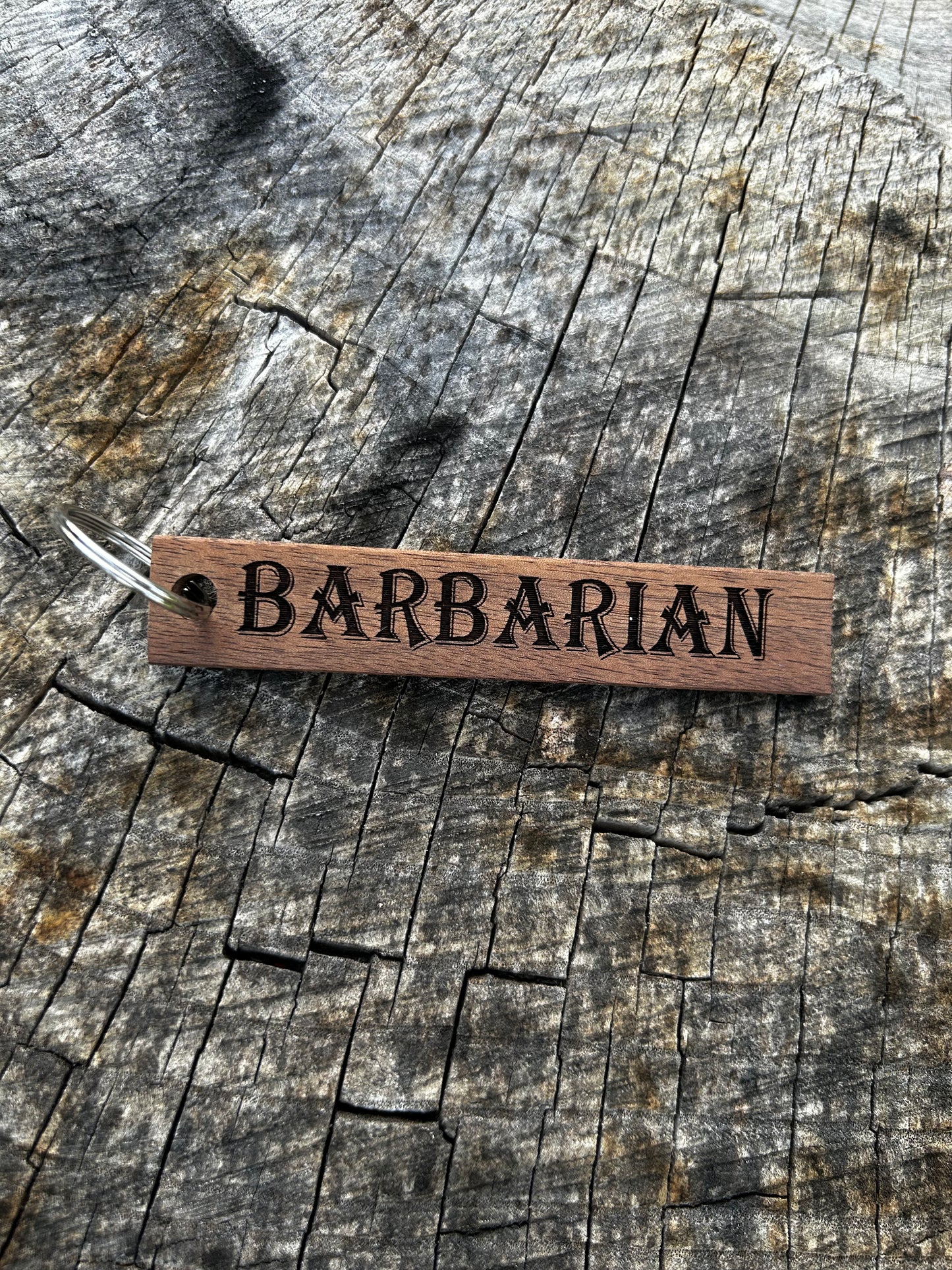 Willow Wooden Keychain with the word "Barbarian" and the Oakley Nerd Nook logo pressed into it