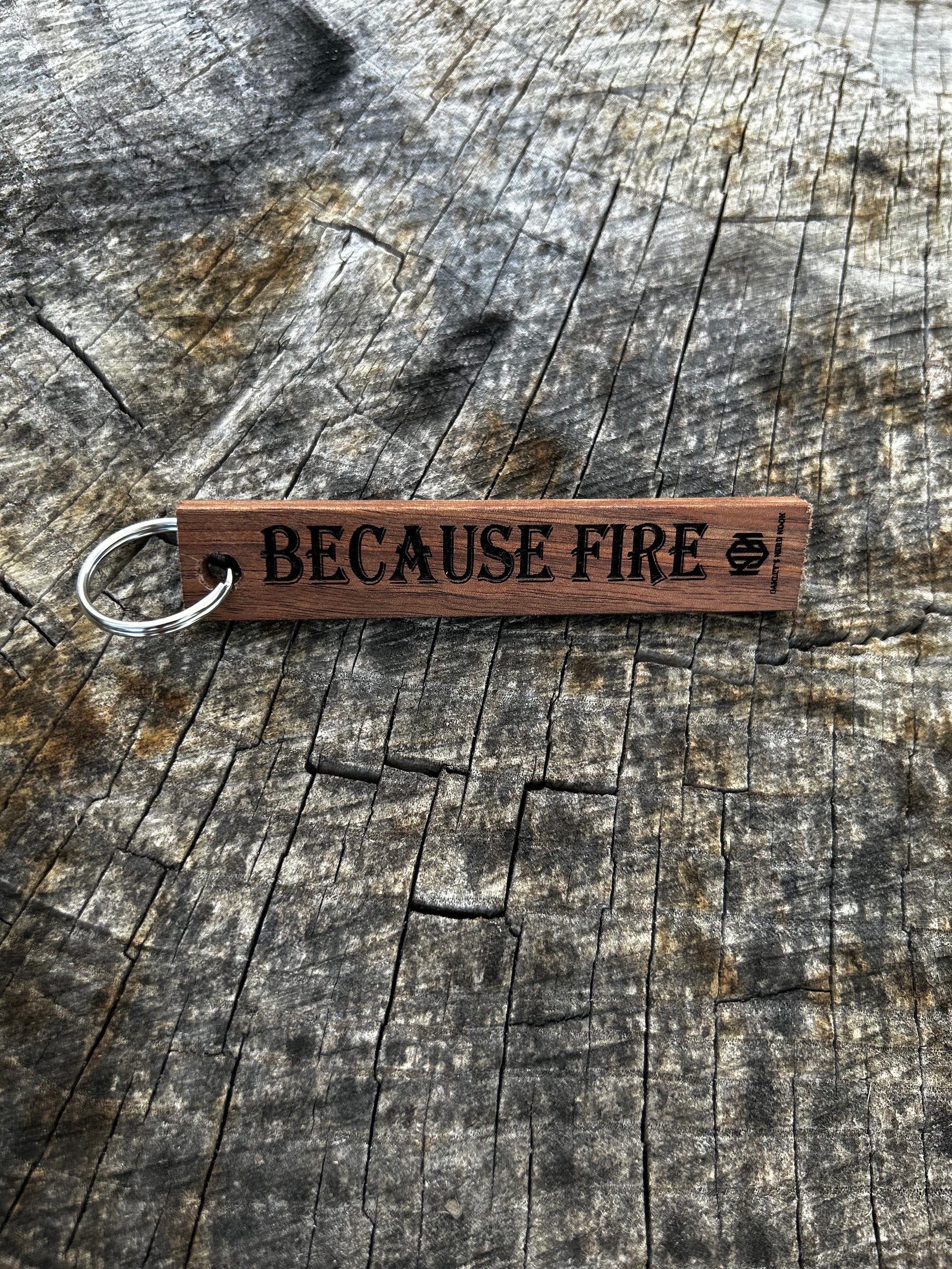 Textured Wooden Keychain with the word "Because Fire" and the Oakley Nerd Nook logo pressed into it