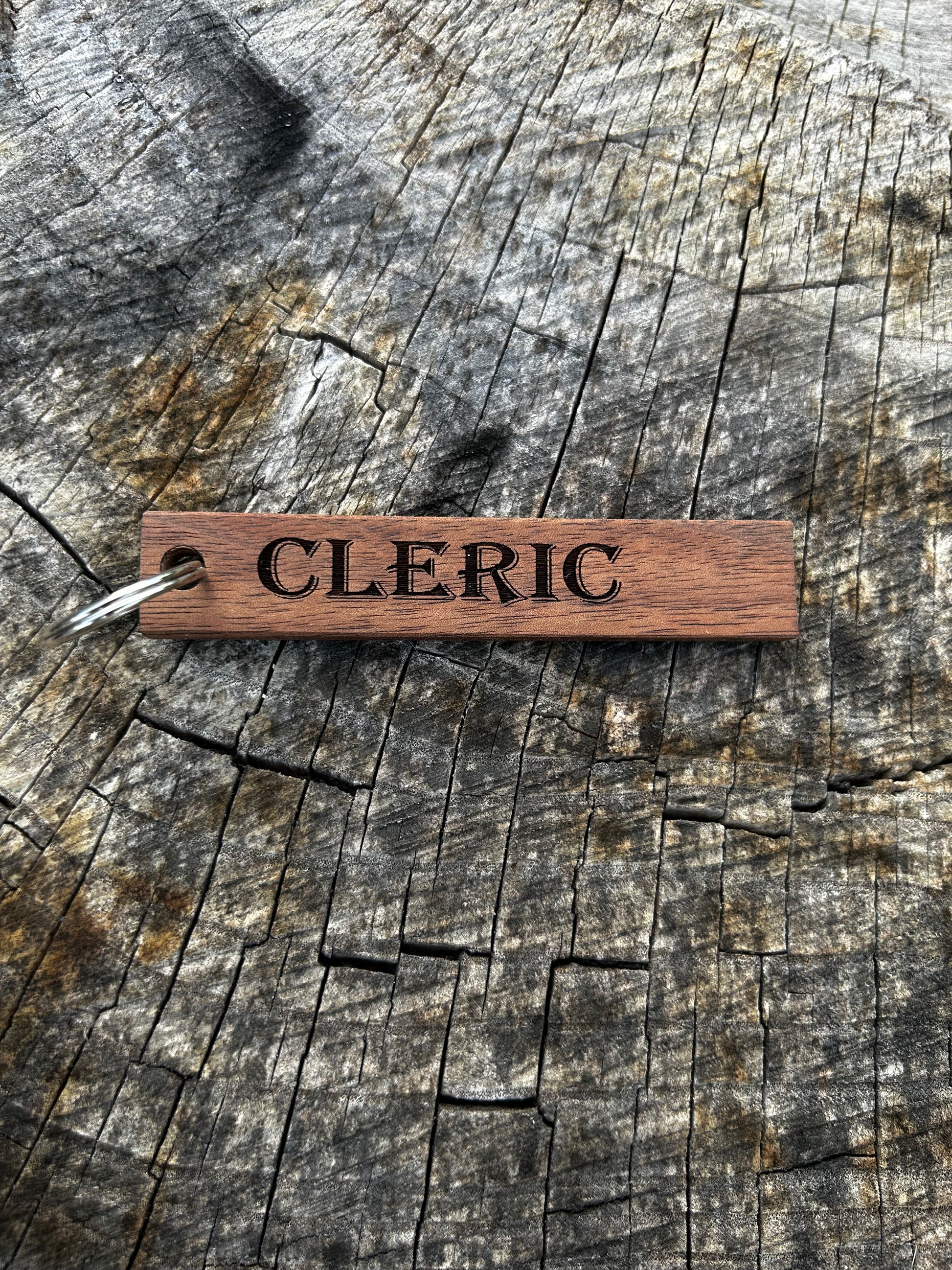 Willow Wooden Keychain with the word "Cleric" and the Oakley Nerd Nook logo pressed into it