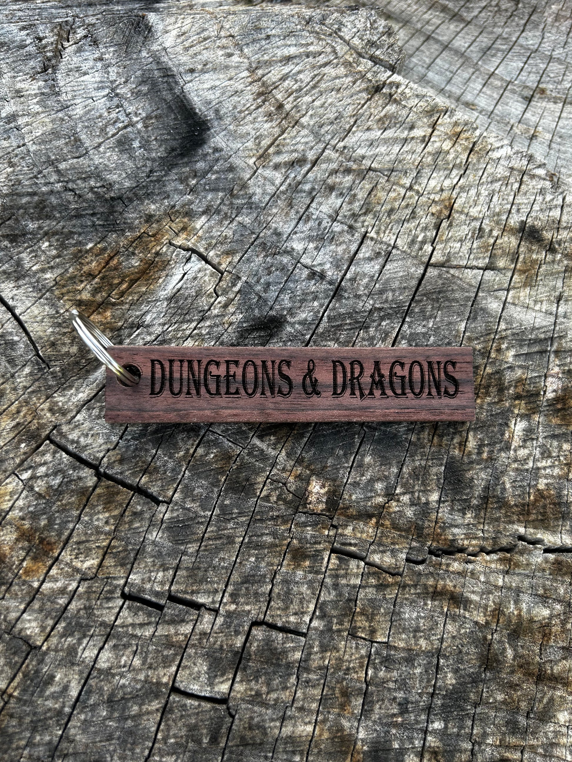 Willow Wooden Keychain with the word "Dungeons & Dragons" and the Oakley Nerd Nook logo pressed into it