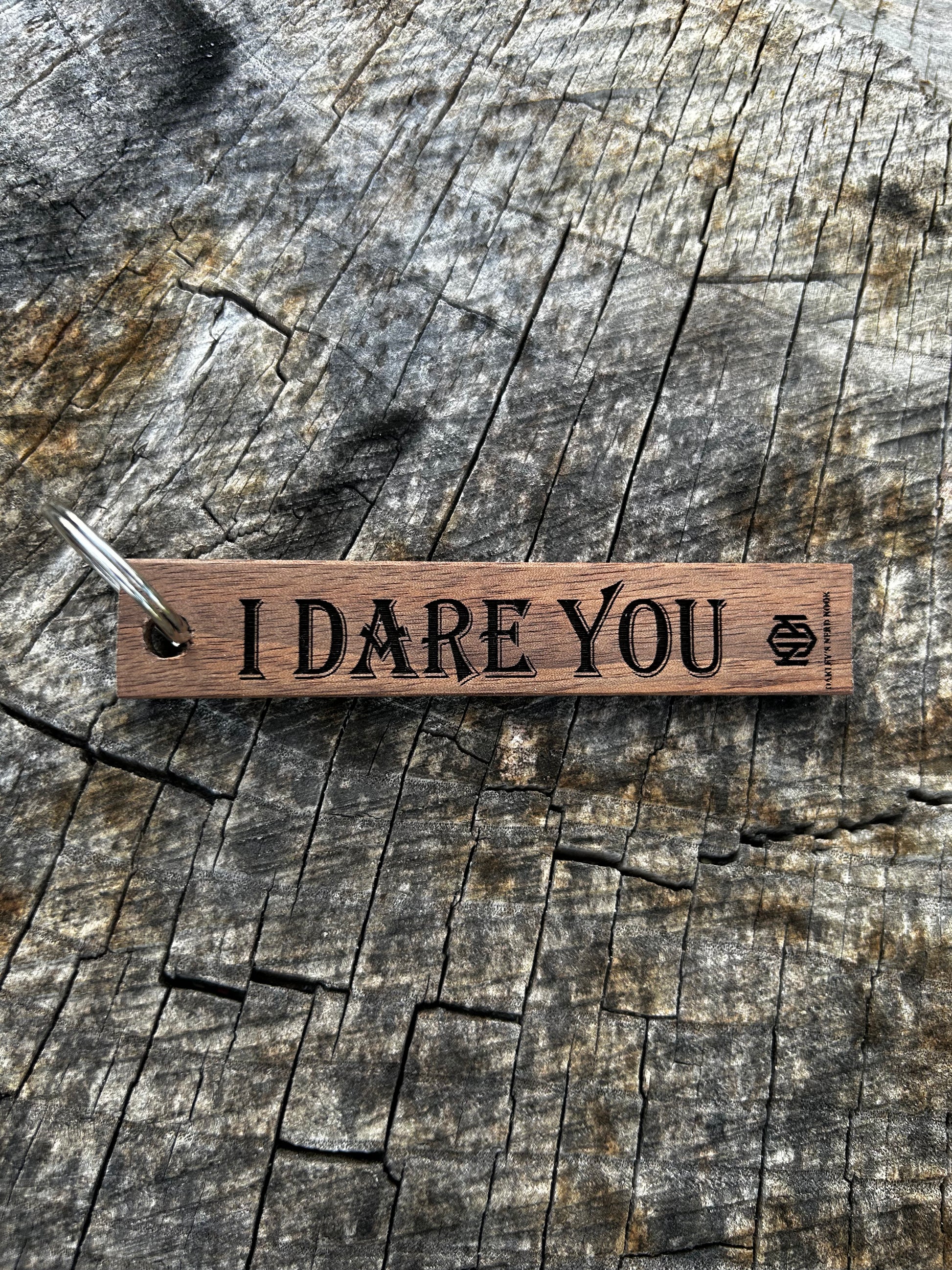 Willow Wooden Keychain with the word "I Dare You" and the Oakley Nerd Nook logo pressed into it