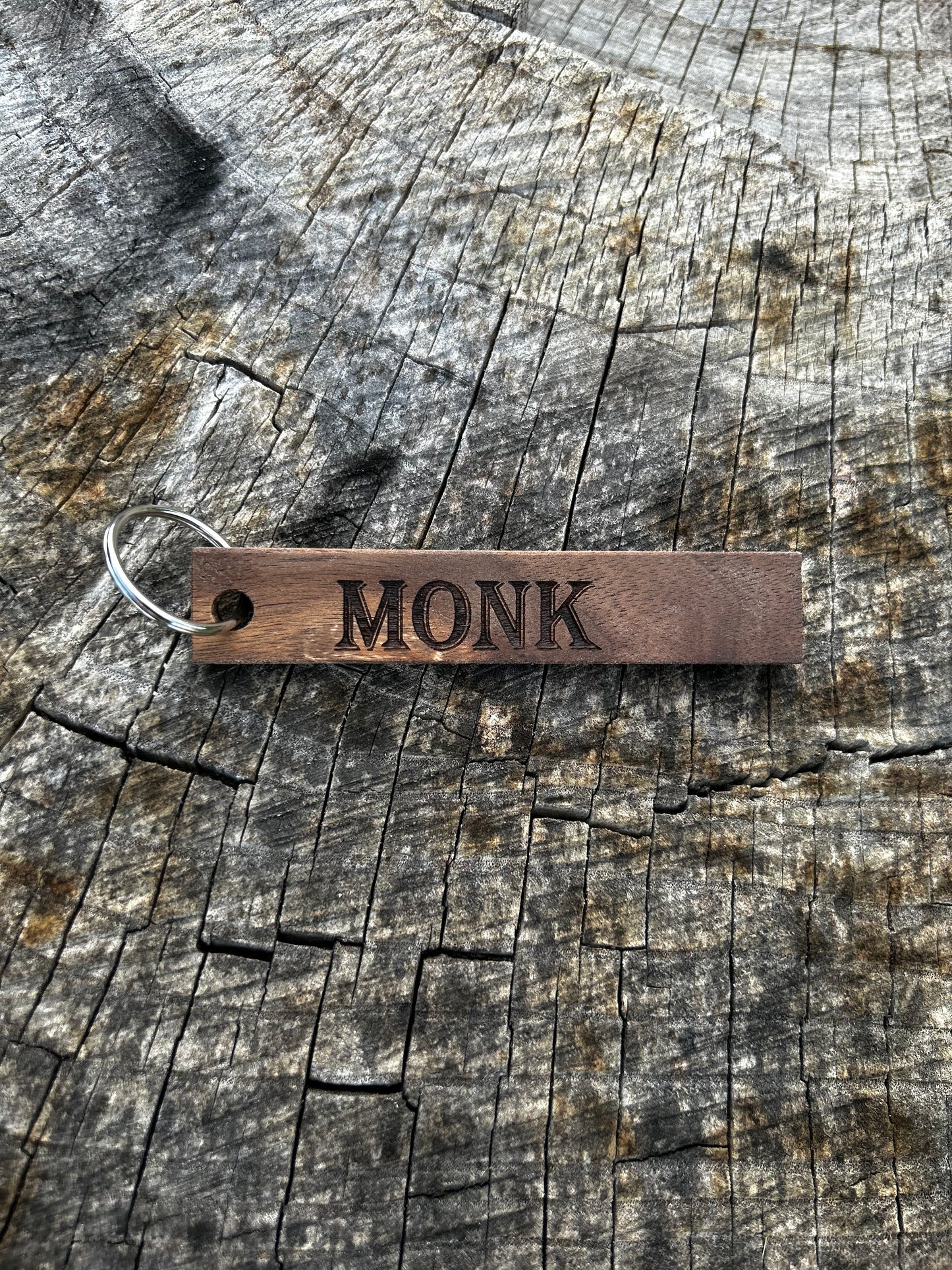 Willow Wooden Keychain with the word "Monk" and the Oakley Nerd Nook logo pressed into it