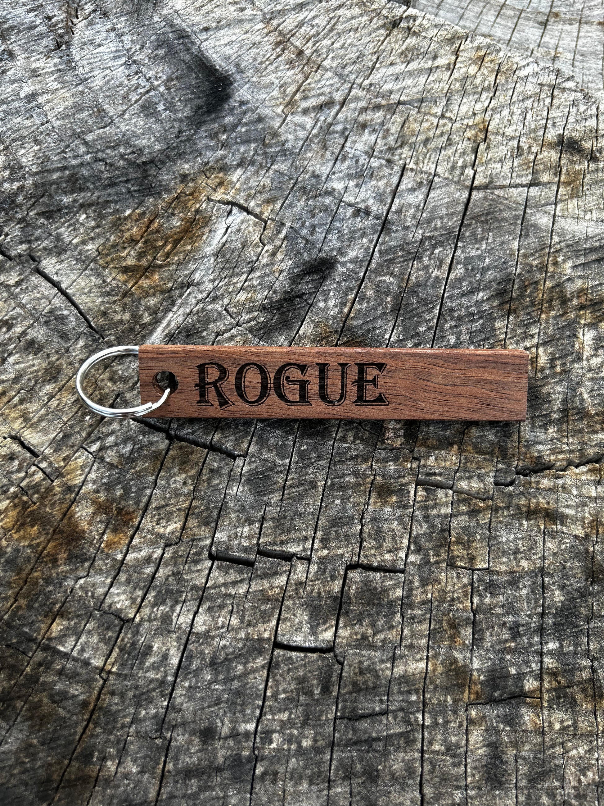 Willow Wooden Keychain with the word "Rogue" and the Oakley Nerd Nook logo pressed into it