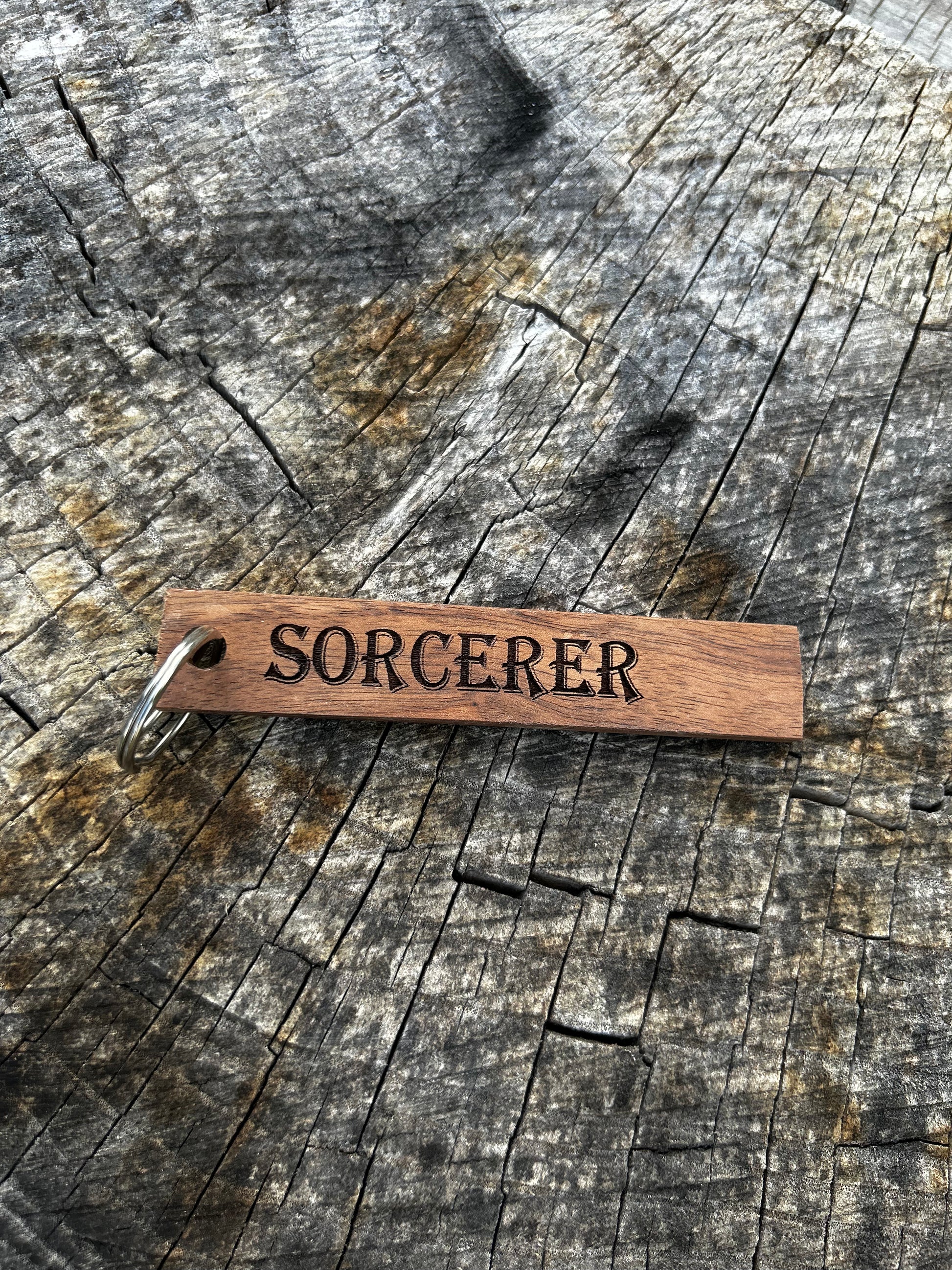 Willow Wooden Keychain with the word "Sorcerer" and the Oakley Nerd Nook logo pressed into it